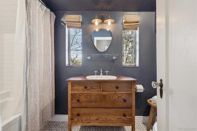 629 Bellaire St, Denver, CO 80220 - bathroom featuring baseboards, toilet, vanity, and shower / tub combo
