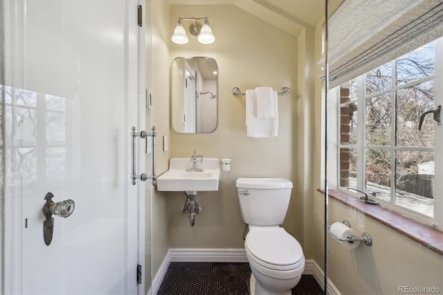 629 Bellaire St, Denver, CO 80220 - bathroom with toilet, baseboards, tile patterned flooring, and a shower