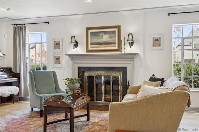 629 Bellaire St, Denver, CO 80220 - living area featuring a fireplace with flush hearth, wood finished floors, and plenty of natural light