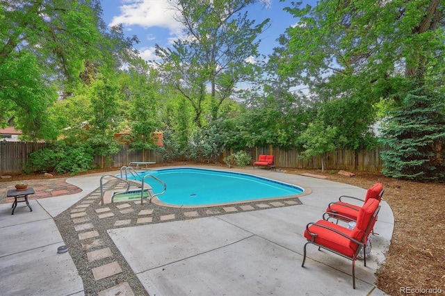 629 Bellaire St, Denver, CO 80220 - view of swimming pool with a fenced backyard, a patio, and view of scattered trees
