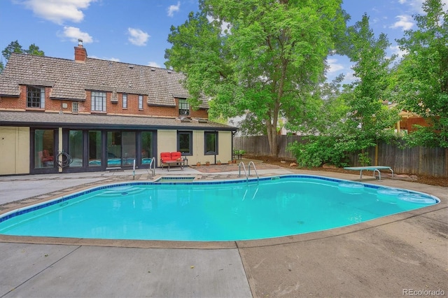 629 Bellaire St, Denver, CO 80220 - view of pool with a fenced backyard, a patio area, and a diving board