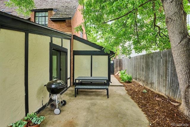 629 Bellaire St, Denver, CO 80220 - fenced backyard featuring a patio, grilling area, and a sunroom