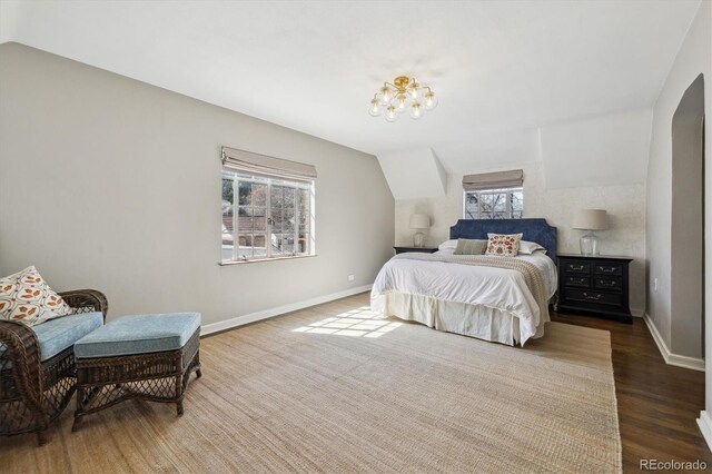 629 Bellaire St, Denver, CO 80220 - bedroom featuring wood finished floors, vaulted ceiling, and a chandelier