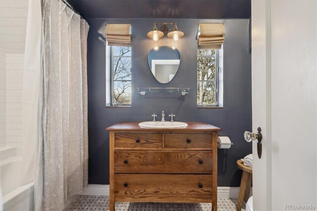 629 Bellaire St, Denver, CO 80220 - bathroom with vanity and shower / tub combo with curtain