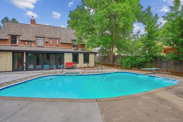 629 Bellaire St, Denver, CO 80220 - view of pool with a fenced backyard, a patio area, and a diving board