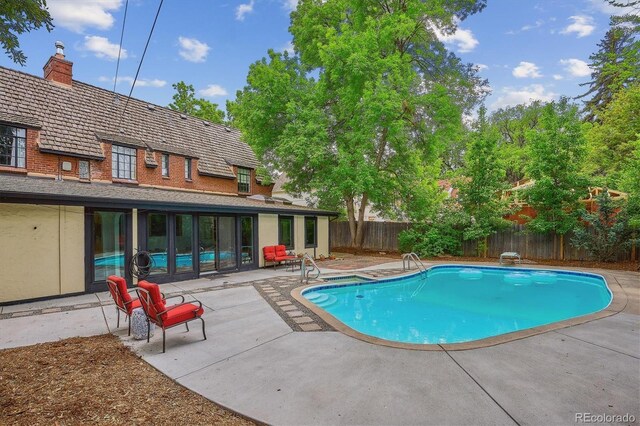 629 Bellaire St, Denver, CO 80220 - view of swimming pool featuring a patio area and a fenced backyard