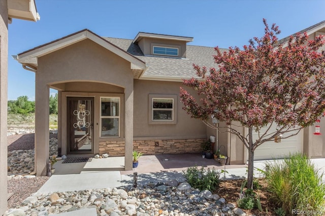 10497 Table Rock Ct, Poncha Springs, CO 81242 - entrance to property with a shingled roof, stone siding, and stucco siding