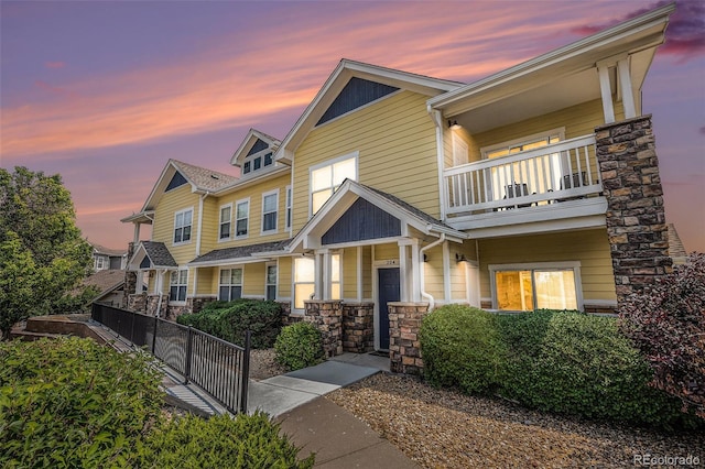 9434 Ashbury Cir Unit 204, Parker, CO 80134 - view of front of house featuring a balcony, stone siding, and a porch