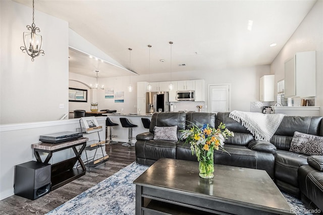 9434 Ashbury Cir Unit 204, Parker, CO 80134 - living room with a chandelier, dark wood-style floors, and lofted ceiling