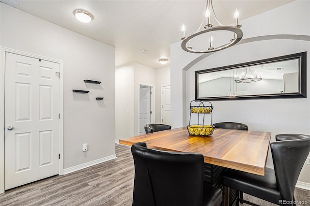 9434 Ashbury Cir Unit 204, Parker, CO 80134 - dining room with wood finished floors, baseboards, and a chandelier