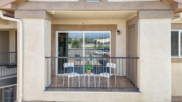 875 E 78th Ave Unit 21, Denver, CO 80229 - doorway to property featuring stucco siding