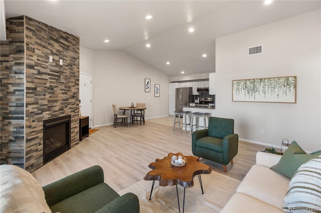 875 E 78th Ave Unit 21, Denver, CO 80229 - living room with a fireplace, light wood-style floors, baseboards, lofted ceiling, and recessed lighting