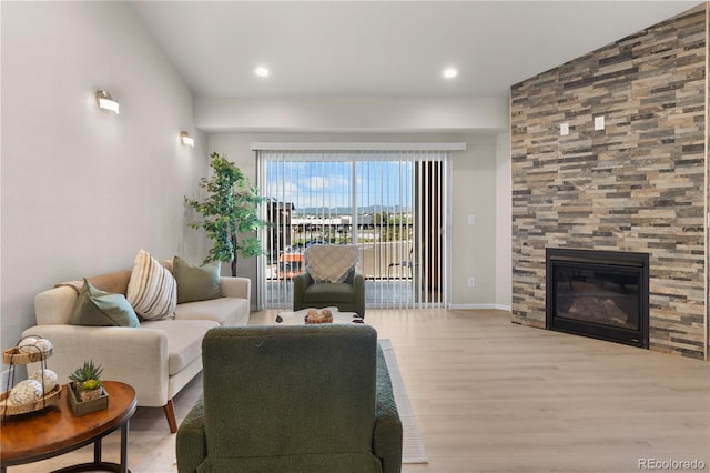 875 E 78th Ave Unit 21, Denver, CO 80229 - living area featuring wood finished floors, a tiled fireplace, baseboards, and recessed lighting