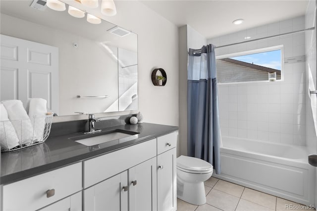 875 E 78th Ave Unit 21, Denver, CO 80229 - bathroom with toilet, tile patterned floors, vanity, and shower / bath combo with shower curtain