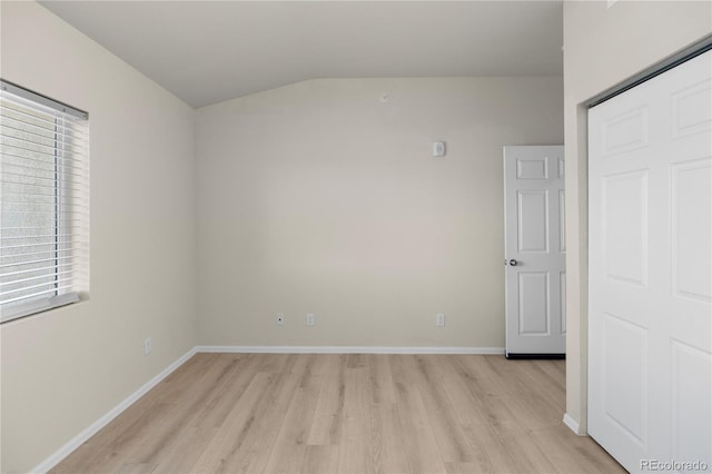 875 E 78th Ave Unit 21, Denver, CO 80229 - empty room with light wood-type flooring, vaulted ceiling, and baseboards