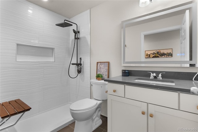 875 E 78th Ave Unit 21, Denver, CO 80229 - bathroom with toilet, vanity, tiled shower, and tile patterned floors
