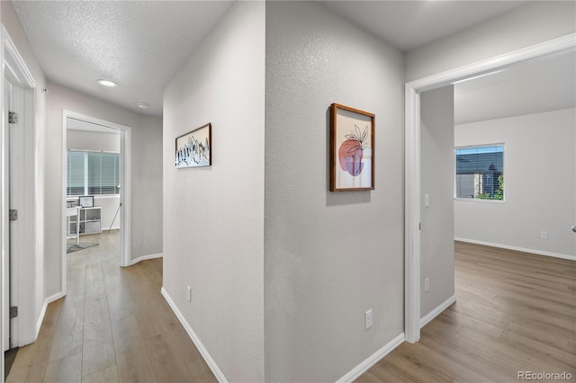 875 E 78th Ave Unit 21, Denver, CO 80229 - hall featuring light wood-type flooring, baseboards, and recessed lighting