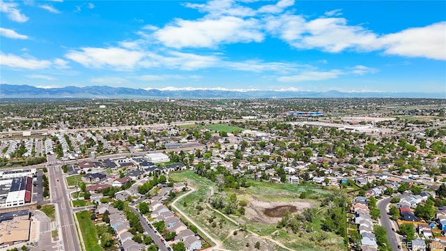 875 E 78th Ave Unit 21, Denver, CO 80229 - aerial overview of property's location featuring a mountain backdrop and nearby suburban area