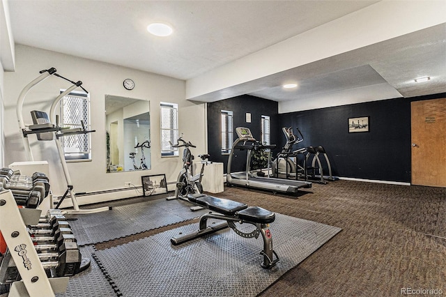 workout area featuring carpet and a baseboard heating unit