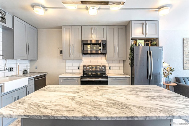 kitchen with gray cabinets and stainless steel appliances