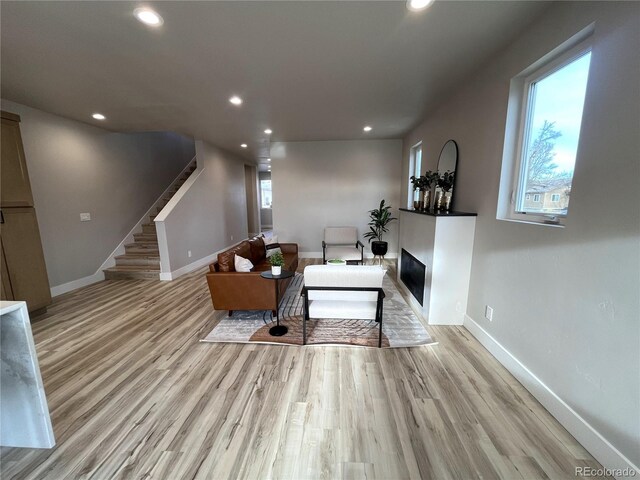 living room featuring a wealth of natural light and light hardwood / wood-style flooring