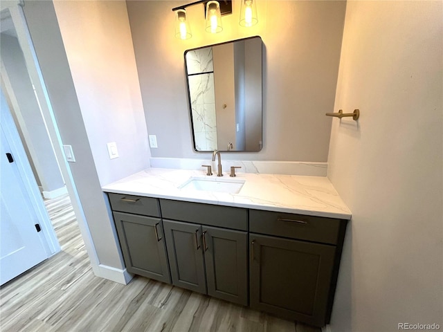 bathroom with hardwood / wood-style flooring and vanity