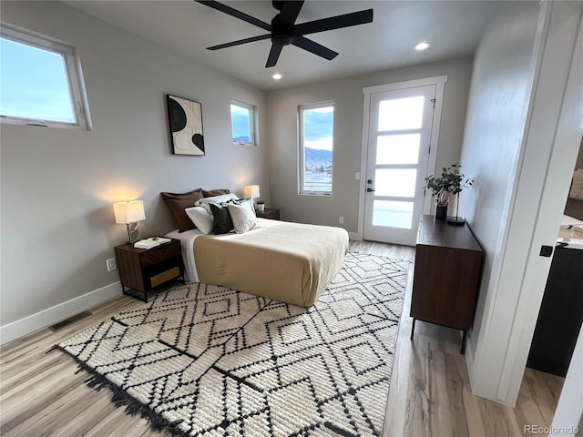 bedroom with ceiling fan, access to outside, and light hardwood / wood-style flooring