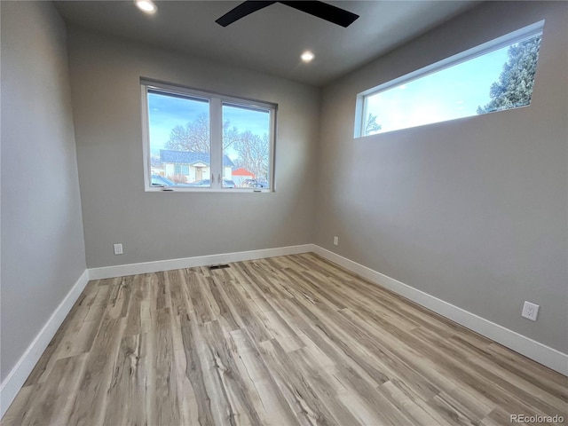 empty room featuring ceiling fan and light hardwood / wood-style flooring