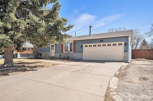 view of front of home with an attached garage, fence, brick siding, and driveway