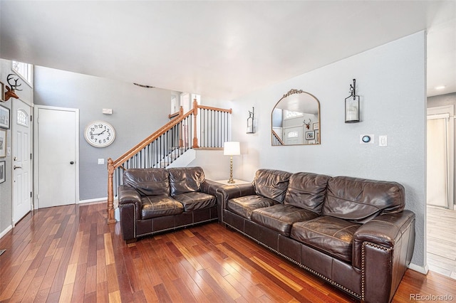 living room featuring stairway, baseboards, and hardwood / wood-style floors