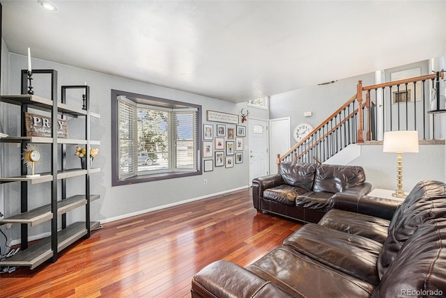 living room with stairway, visible vents, baseboards, and wood-type flooring