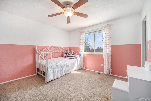 bedroom with visible vents, a textured ceiling, a textured wall, and carpet floors