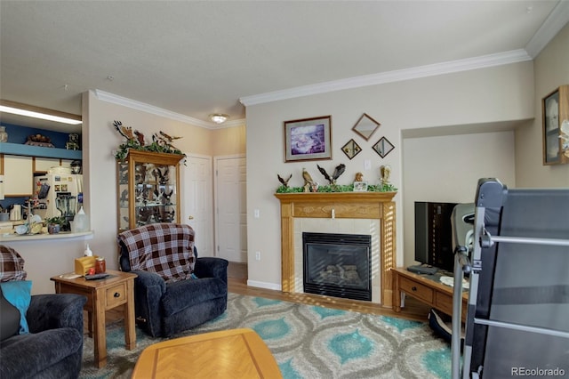 living room with hardwood / wood-style flooring, ornamental molding, and a fireplace