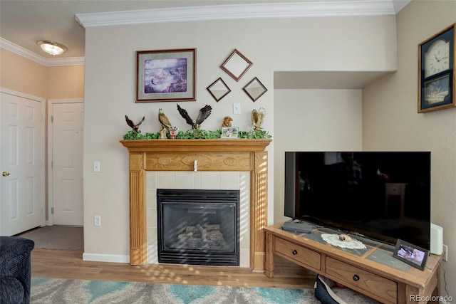 living room featuring hardwood / wood-style flooring, ornamental molding, and a fireplace