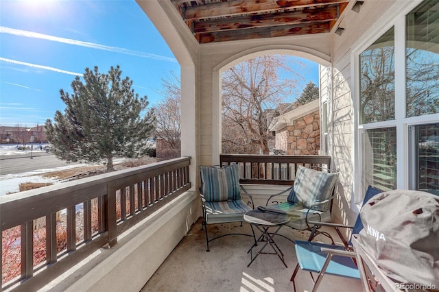 balcony with a sunroom and grilling area