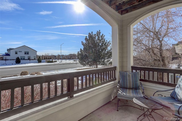 view of snow covered back of property