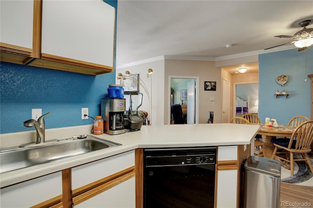 kitchen featuring a peninsula, a sink, ornamental molding, and dishwasher