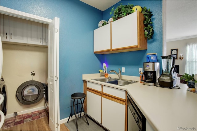 19049 E Warren Dr Unit 105, Aurora, CO 80013 - kitchen featuring light wood-style floors, white cabinets, light countertops, dishwashing machine, and ornamental molding