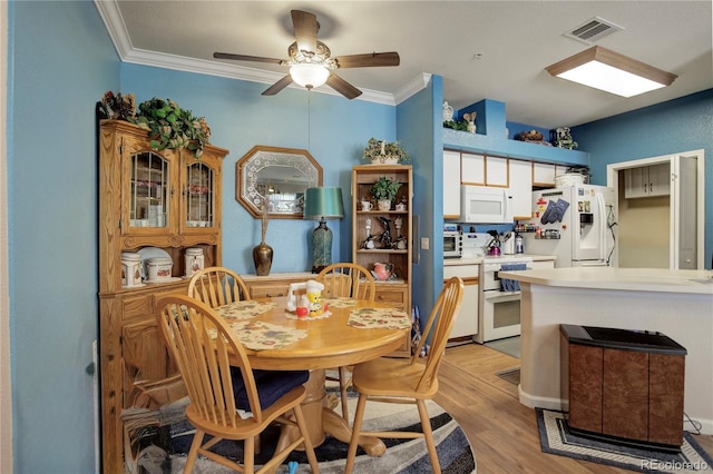 19049 E Warren Dr Unit 105, Aurora, CO 80013 - dining space featuring ornamental molding, light wood-style flooring, and ceiling fan