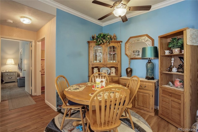 19049 E Warren Dr Unit 105, Aurora, CO 80013 - dining area with light wood finished floors, ceiling fan, and ornamental molding