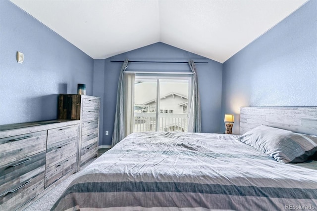 bedroom featuring vaulted ceiling and access to outside