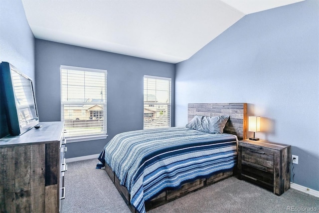 bedroom with carpet floors, vaulted ceiling, multiple windows, and baseboards