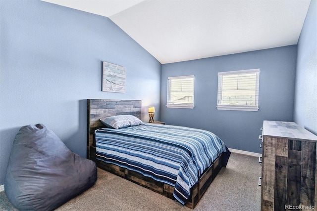 carpeted bedroom featuring vaulted ceiling and baseboards