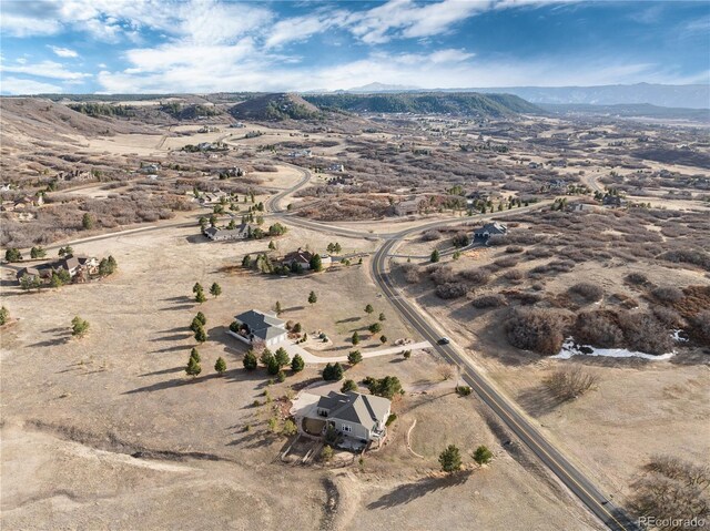 aerial view featuring a mountain view, a desert view, and a rural view