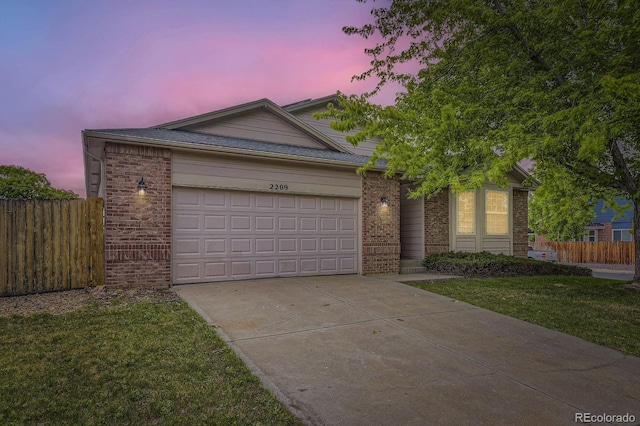 2209 S Flanders St, Aurora, CO 80013 - view of front of property with brick siding, concrete driveway, and an attached garage