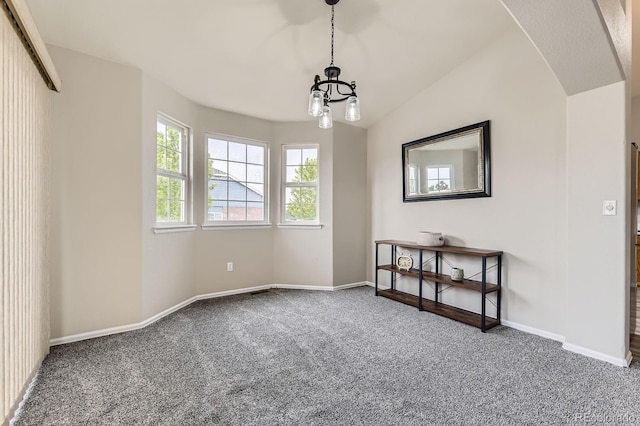 2209 S Flanders St, Aurora, CO 80013 - carpeted empty room with a chandelier, baseboards, arched walkways, and lofted ceiling