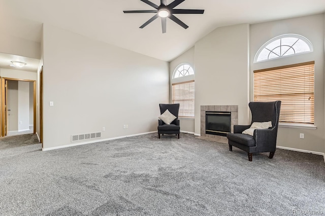2209 S Flanders St, Aurora, CO 80013 - living area featuring a ceiling fan, carpet floors, high vaulted ceiling, baseboards, and a tiled fireplace