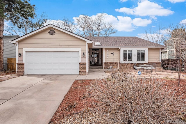 ranch-style home featuring an attached garage, driveway, roof with shingles, and brick siding