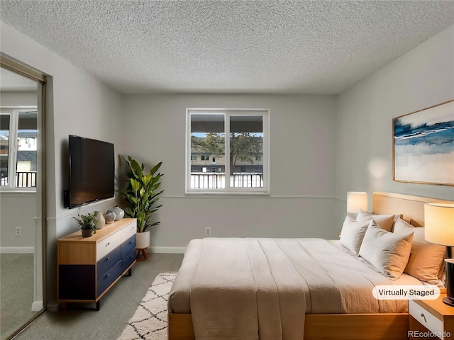 carpeted bedroom with a textured ceiling