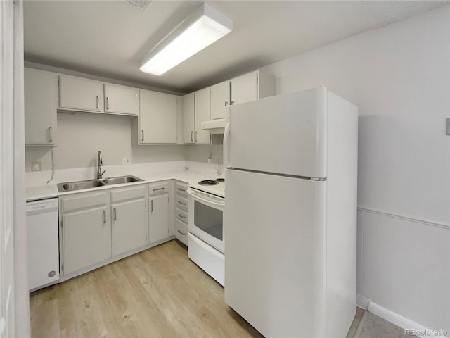 kitchen with white cabinets, sink, white appliances, and light hardwood / wood-style flooring